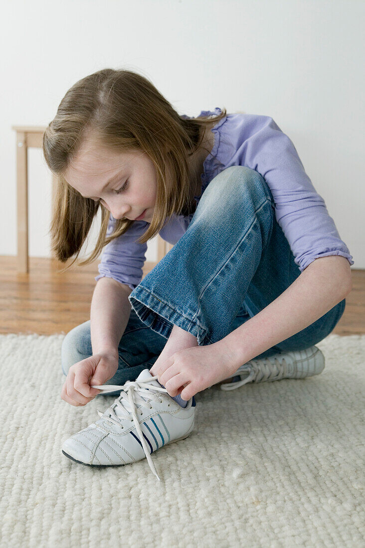 Girl tying shoelace