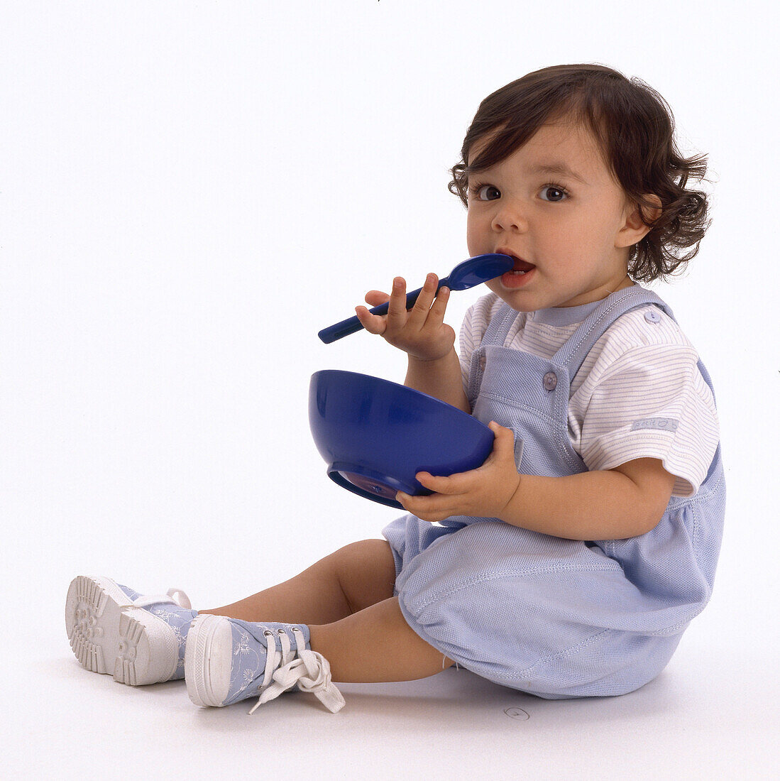 Little girl with bowl and spoon