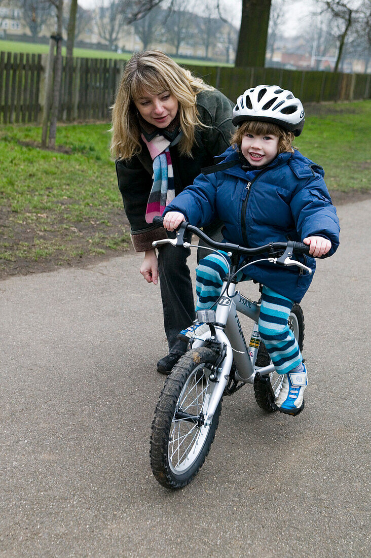 Boy wearing cycling helmet riding bike