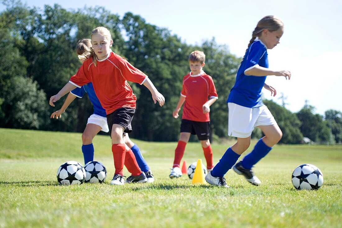 Dribbling ball in and out of coloured cones