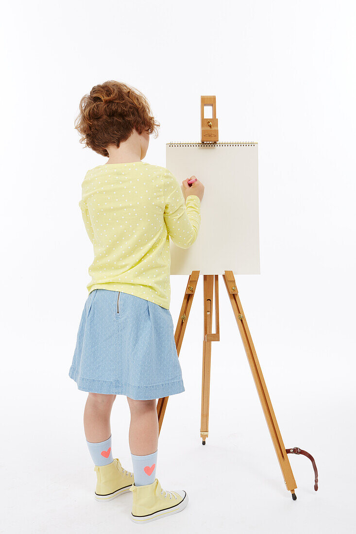Girl painting at easel