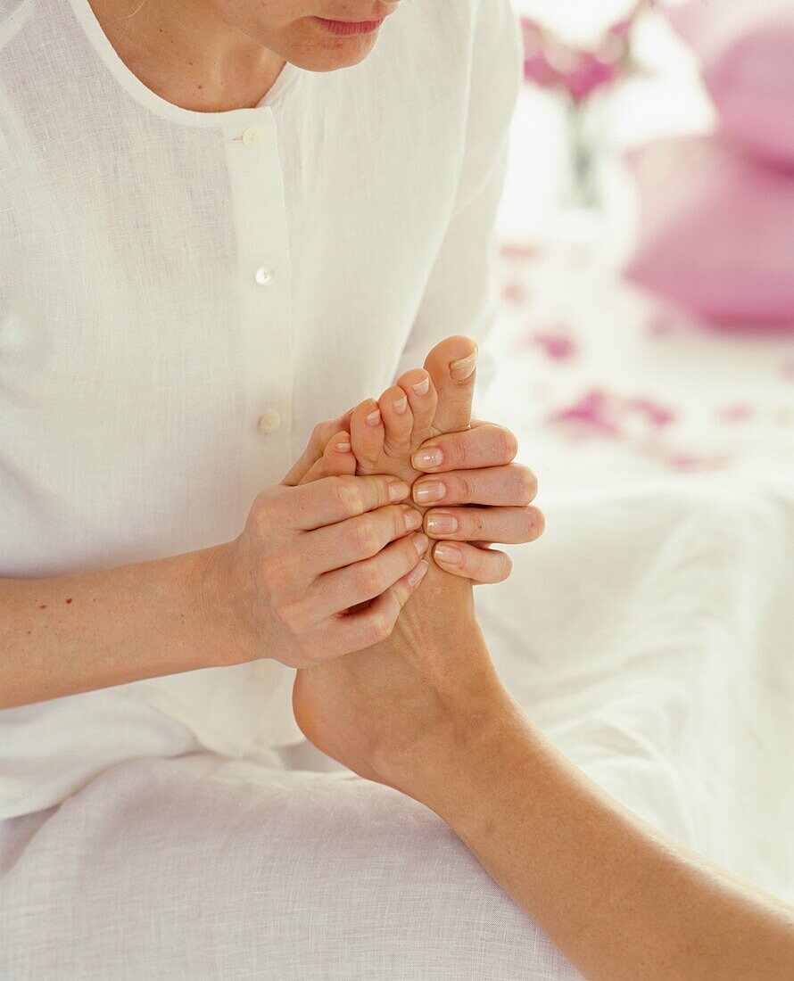 Woman massaging foot