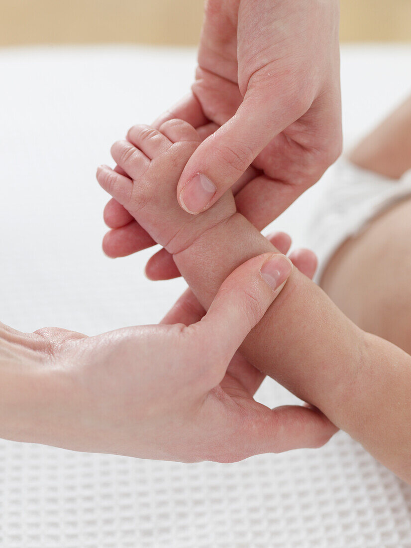 Massaging baby's arm