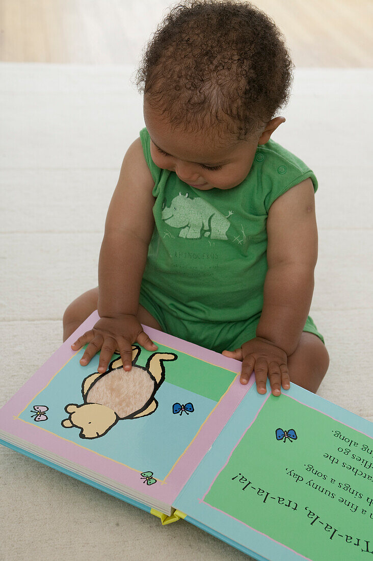 Baby boy reading a book