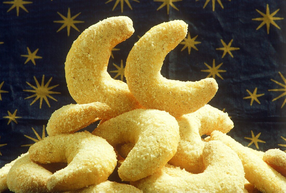 Several vanilla crescents on blue wrapping paper with stars