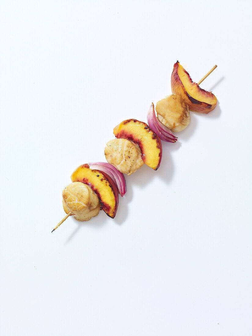 Peach, onion and scallops on skewer