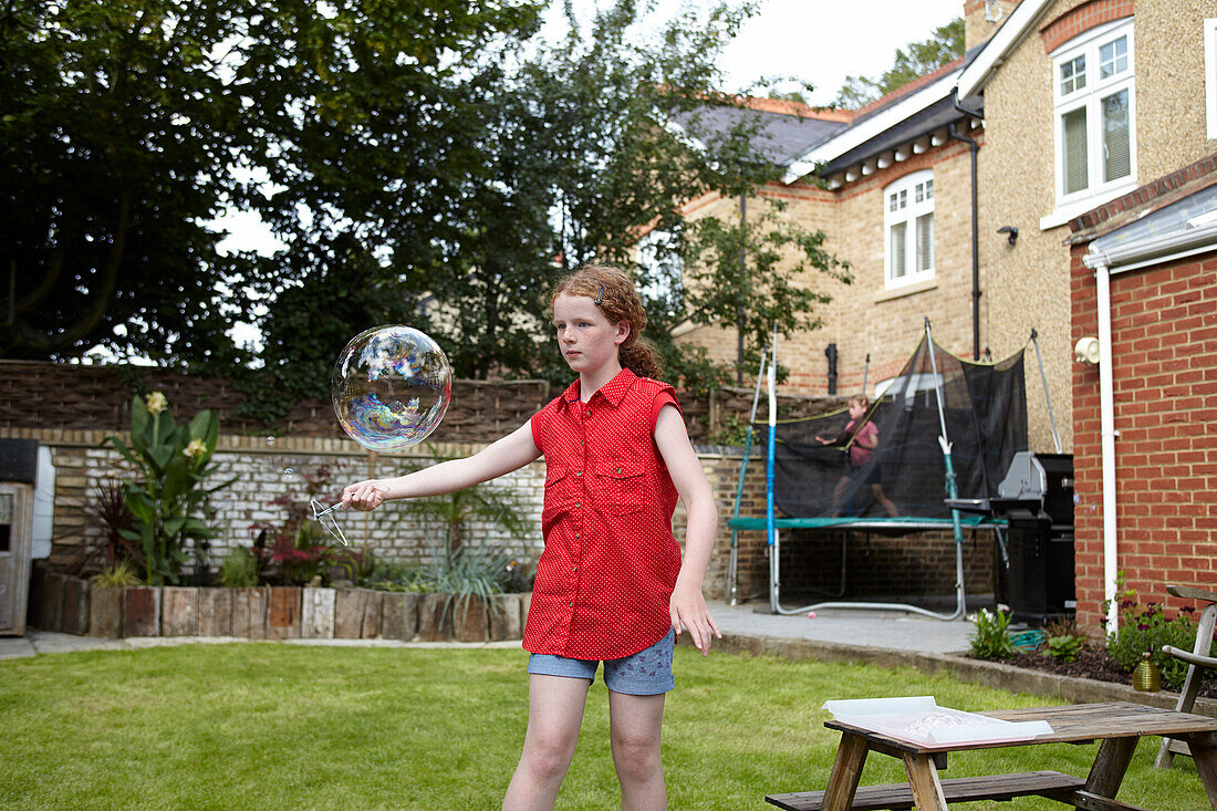 Making bubbles using wire clothes hanger as bubble wand