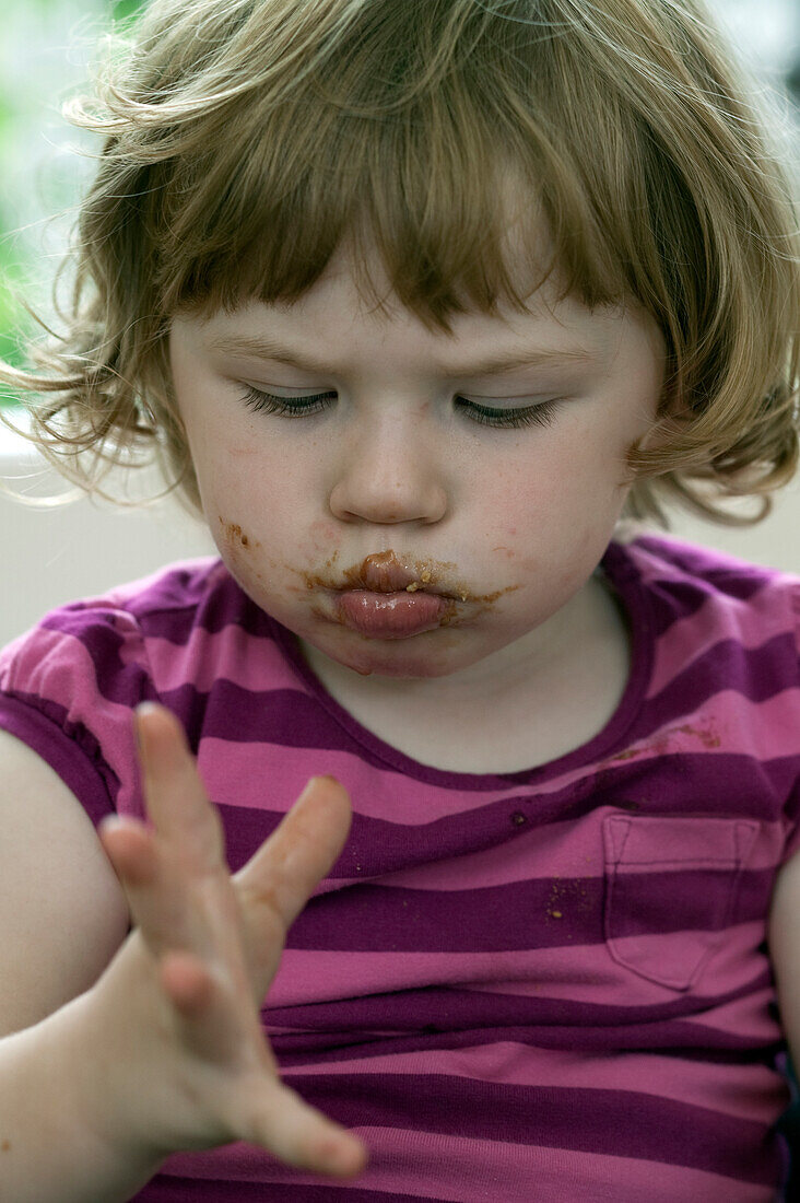 Girl with chocolate around her mouth