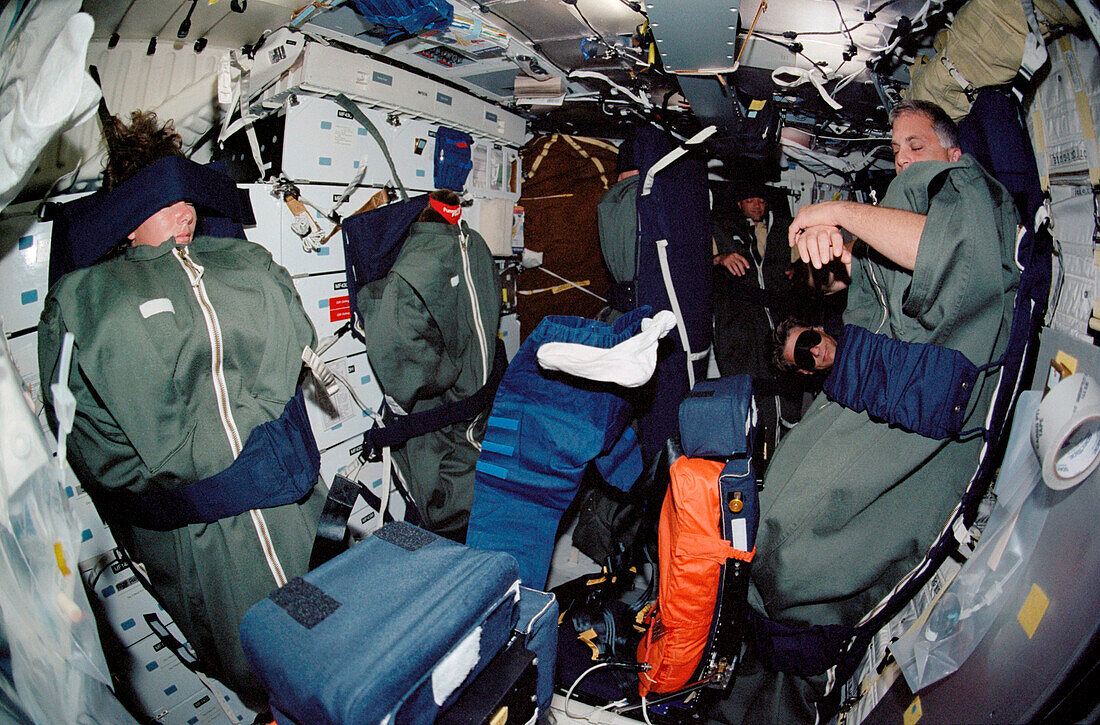 STS-112 crew in their sleep restraints