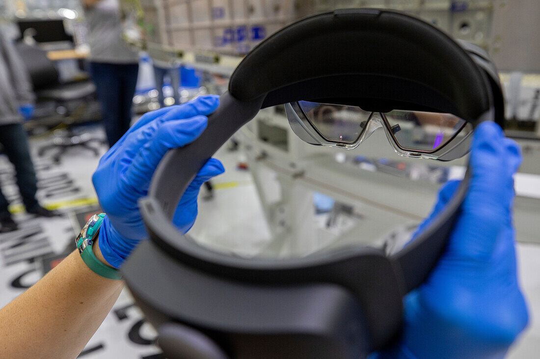 Technician holding augmented reality goggles