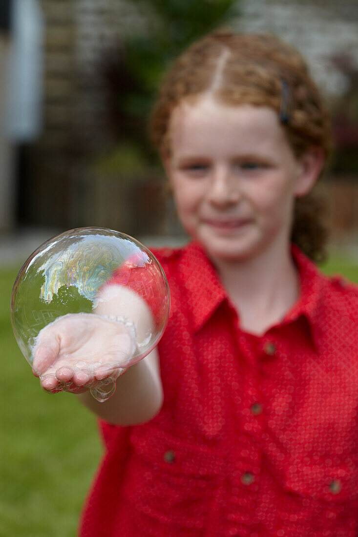 Blowing a hand bubble