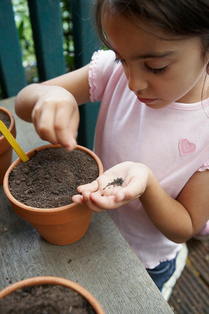 Girl planting lettuce seeds