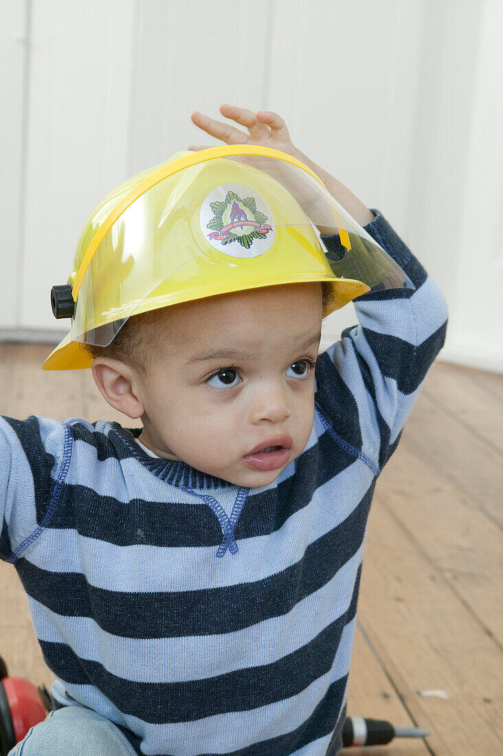 Baby boy wearing yellow helmet