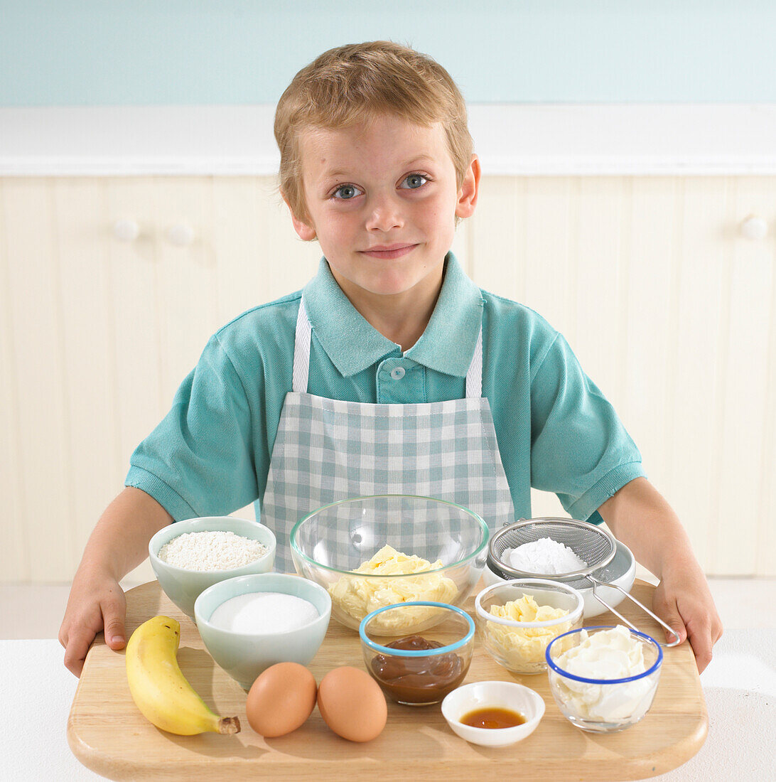 Boy holding the ingredients for banana butterfly cakes
