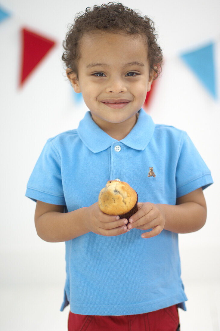 Boy holding muffin