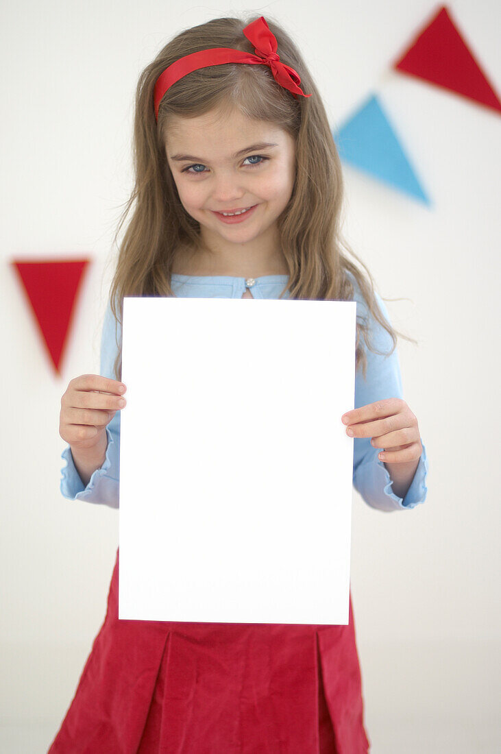 Girl holding piece of blank white paper