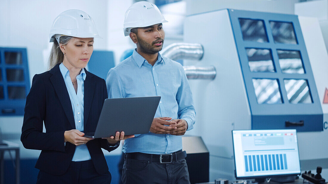 Engineer and manager talking in a factory