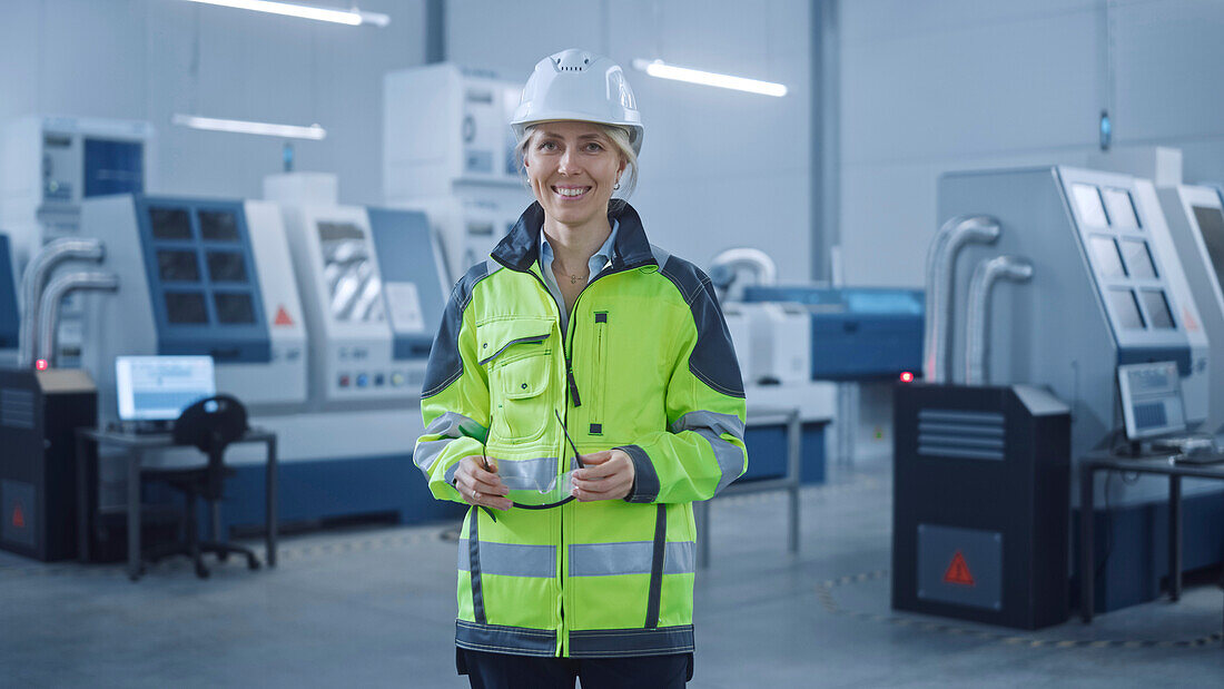 Smiling engineer working in a factory