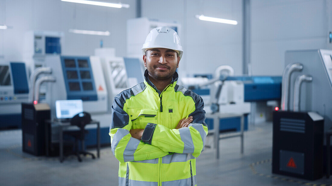 Smiling engineer working in a factory