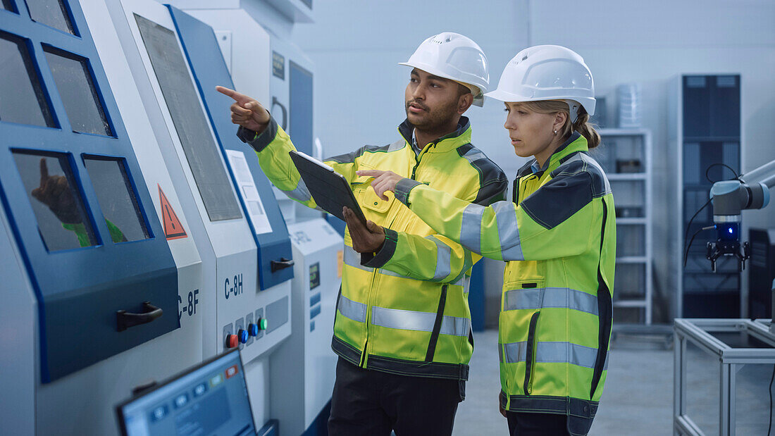 Engineer and manager using a digital tablet controller