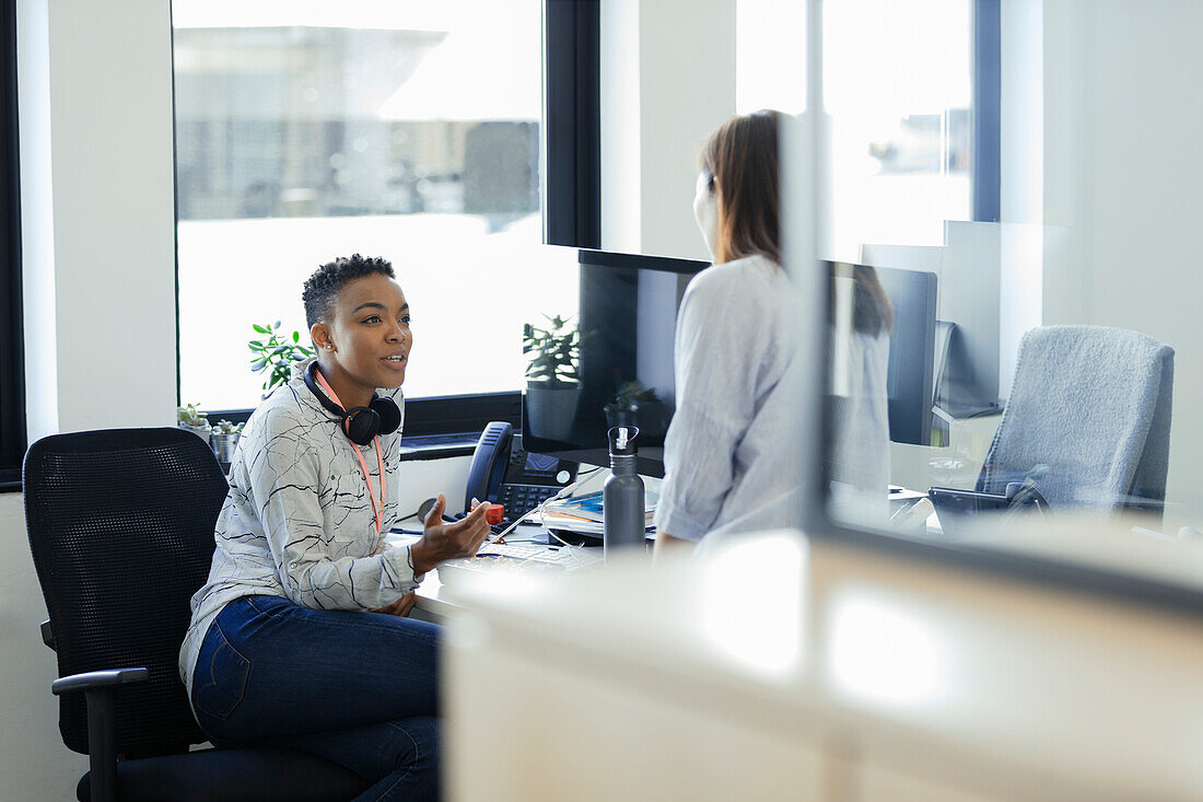 Businesswomen talking to a colleague