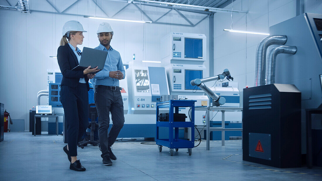 Engineer and manager talking in a factory