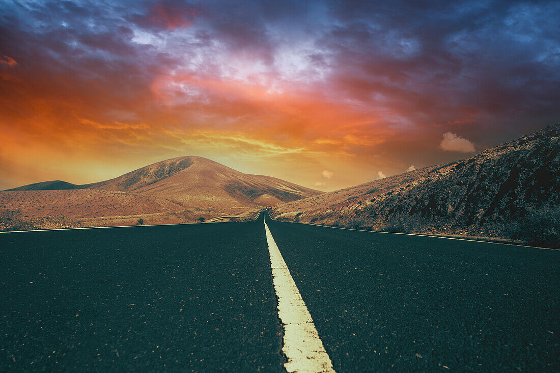 Asphalt road with sunset sky on the horizon