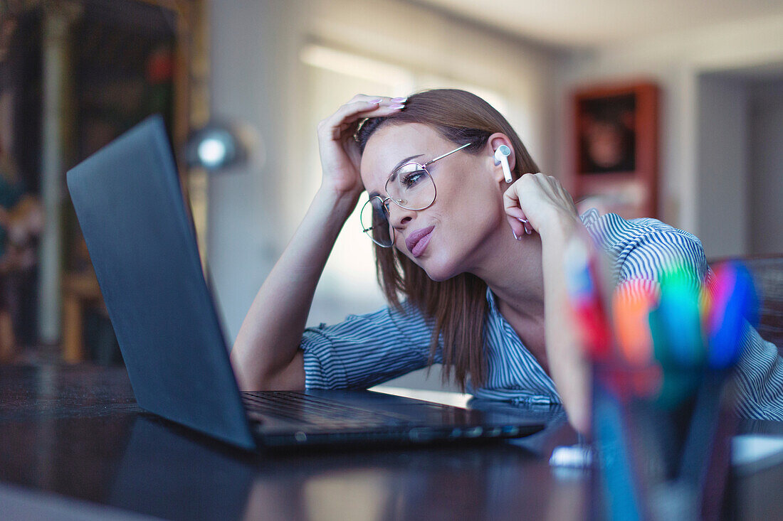 Businesswoman listening to music