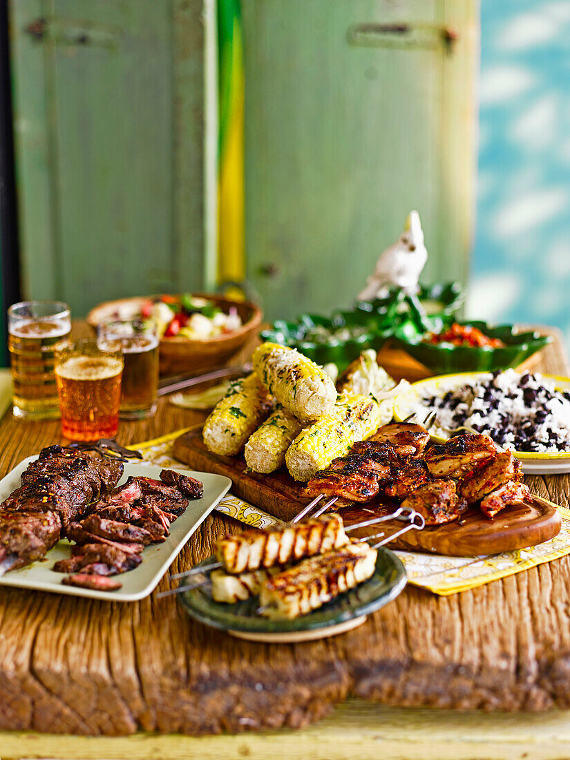 Mixed Barbecue with Black beans and rice, Grilled Corn with Garlic Mayo and grated cheese, Frango Churrasco, Cumin and Onion marinated beef and oregano cheese skewers