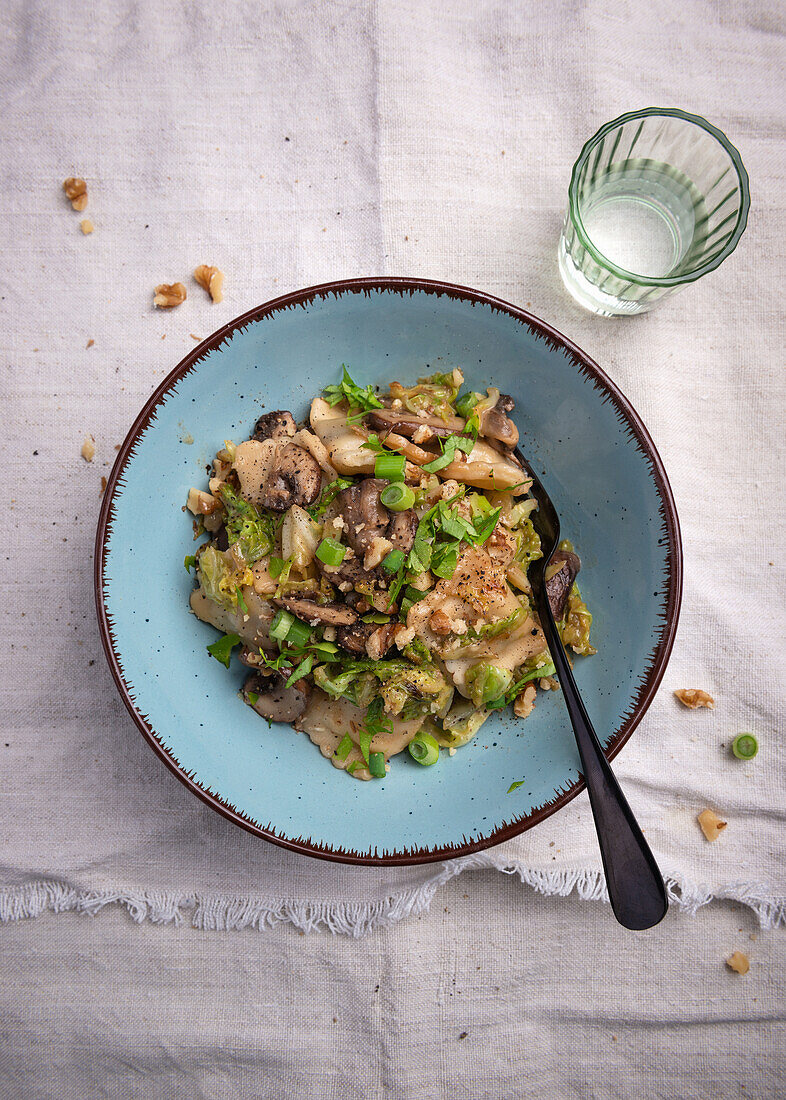 Vegan ravioli with savoy cabbage, brown mushrooms, and walnuts