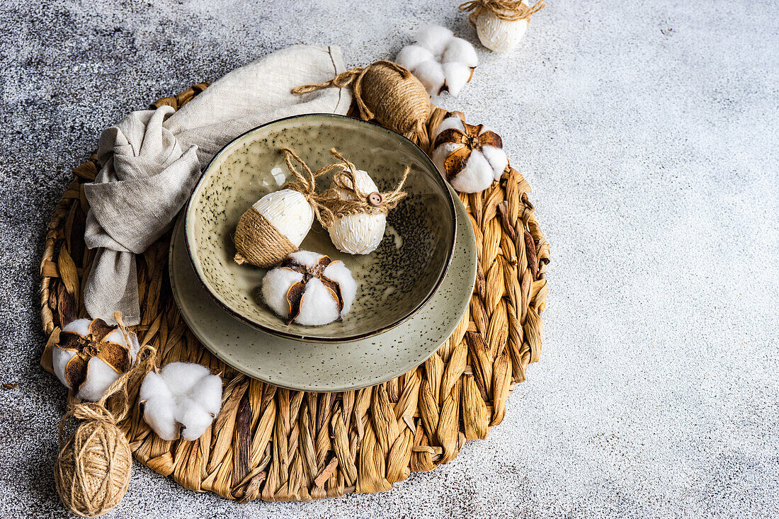 Easter festive table setting with tiny eggs and tableware on stone background