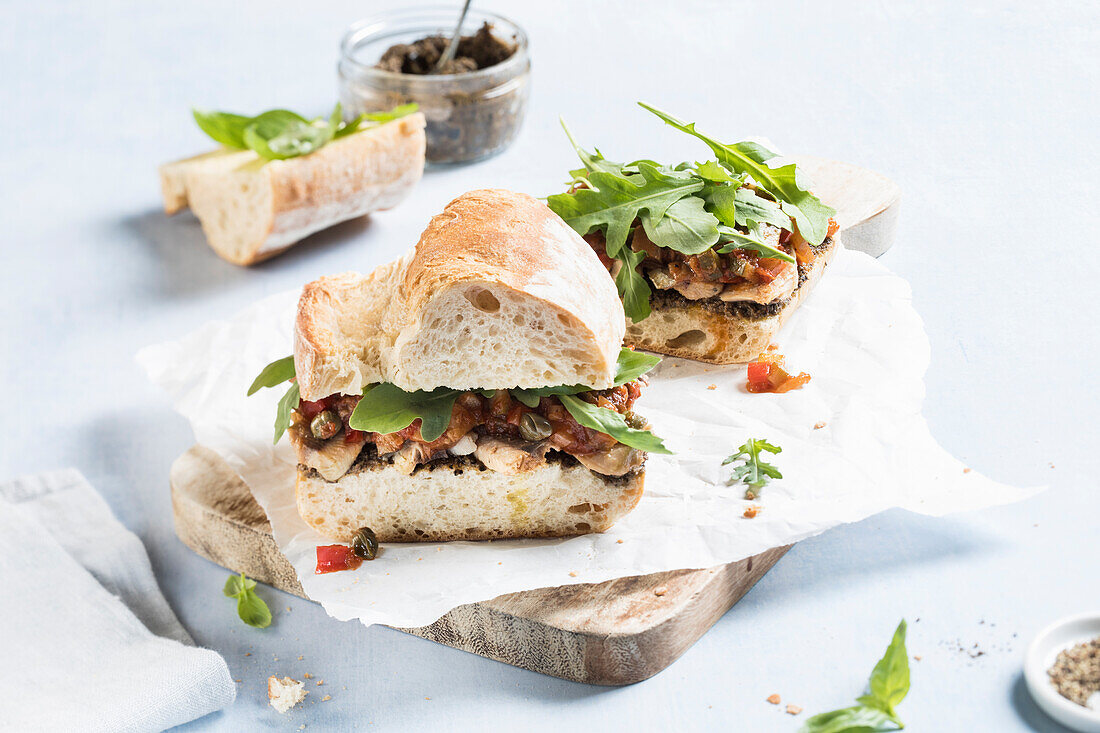 Baguette sandwich with sardines, olive tapenade and ratatouille