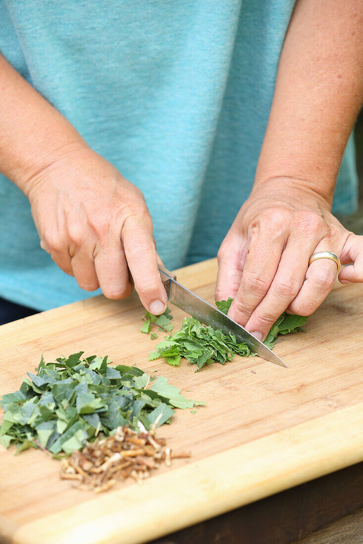 Chopping herb leaves (for hair tonic)