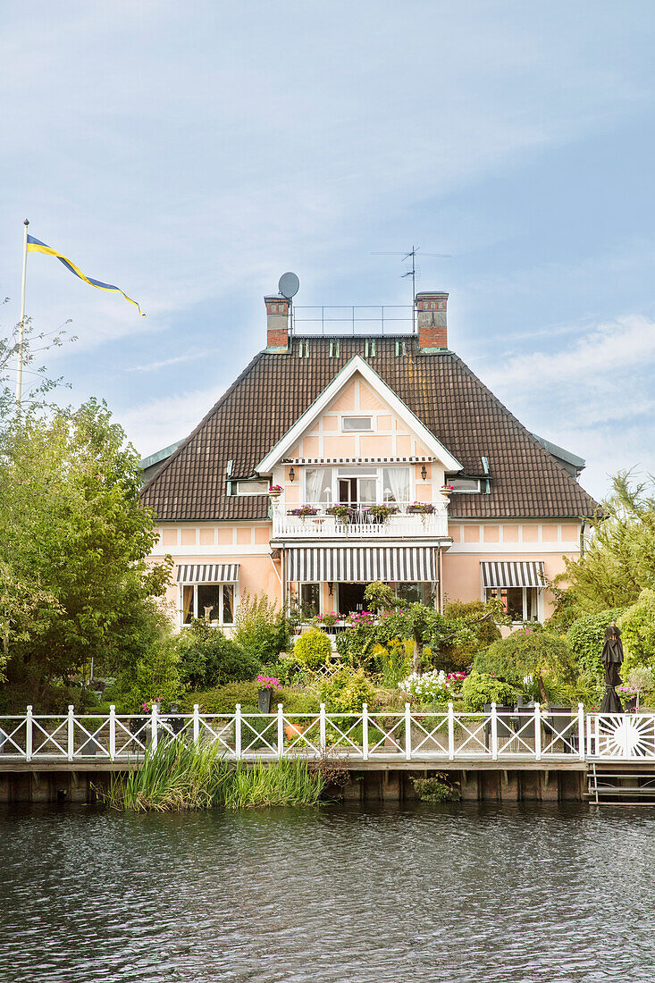 View from the river to the city villa with garden