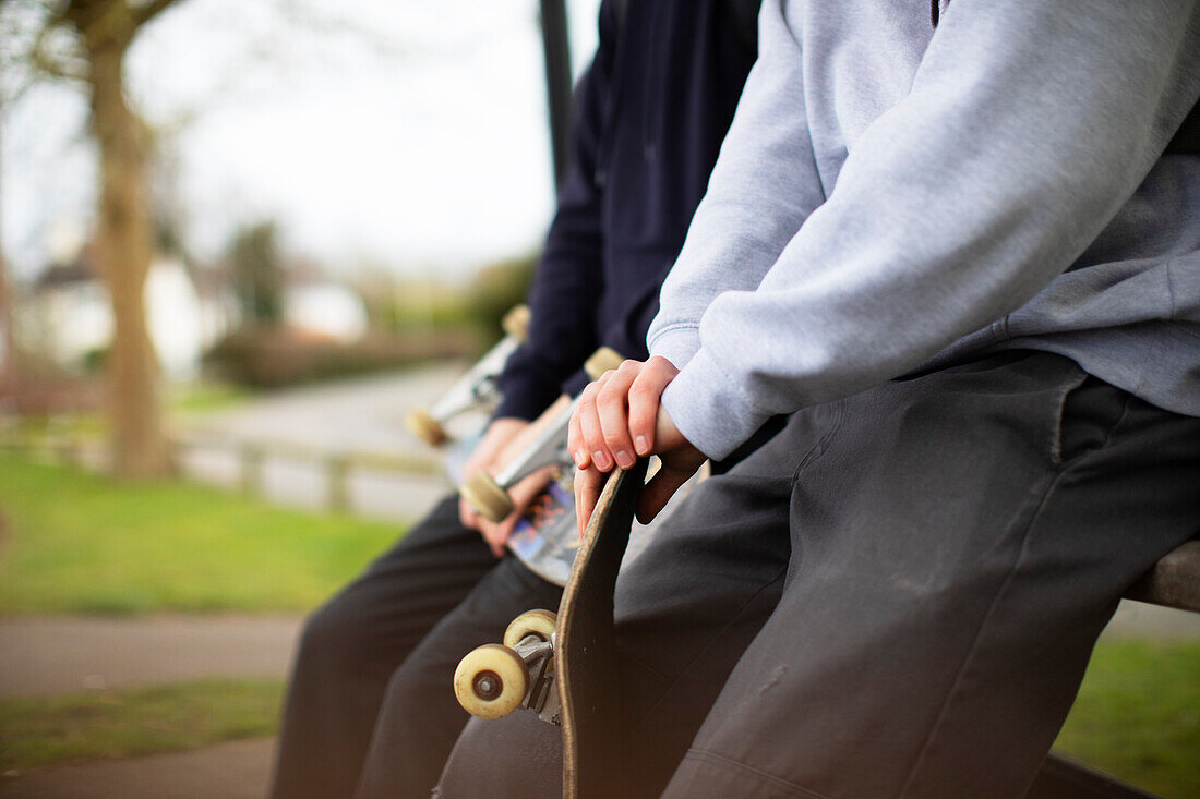 teenage boys with skateboards in park