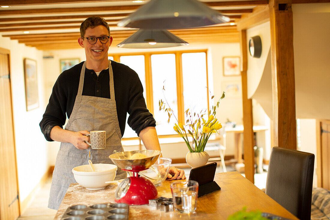 Smiling man baking in kitchen