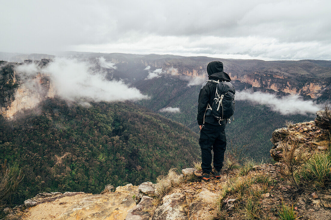 Male hiker on remote mountaintop, Australia