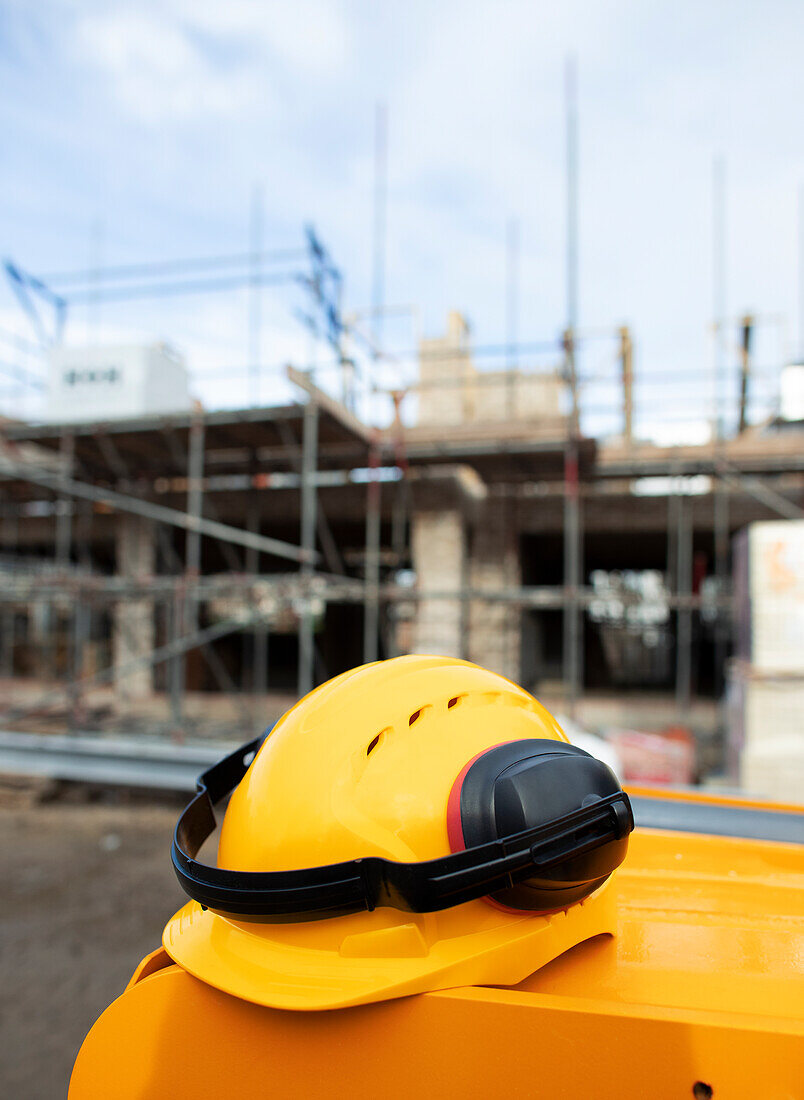 Hard hat with ear protectors at construction site