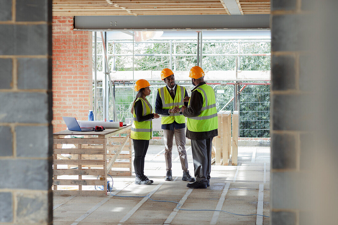 Architects and engineer talking at construction site