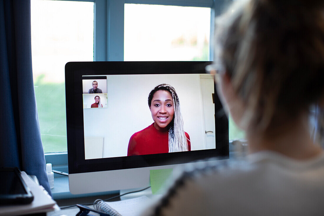 Businesswoman video conferencing with colleagues