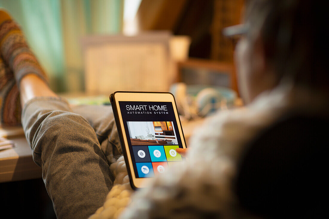 Woman looking at smart home automation on digital tablet