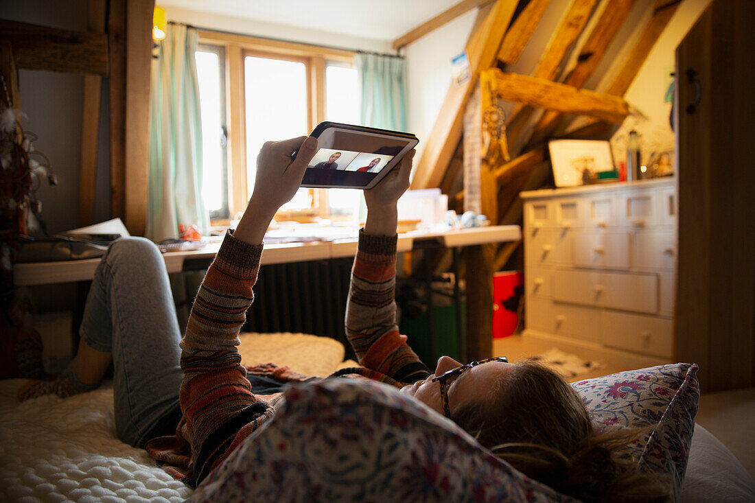 Woman video conferencing with digital tablet from home