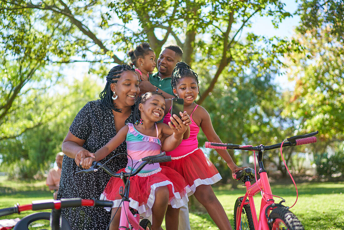 Happy family taking selfie in park