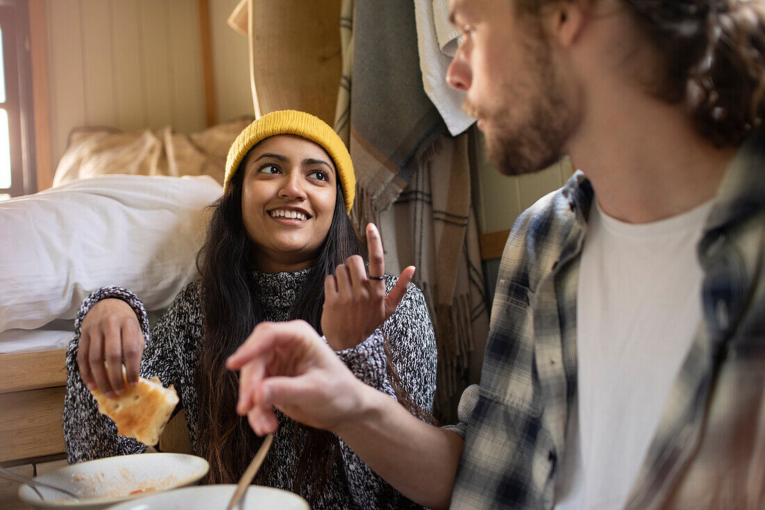 Young couple eating and talking