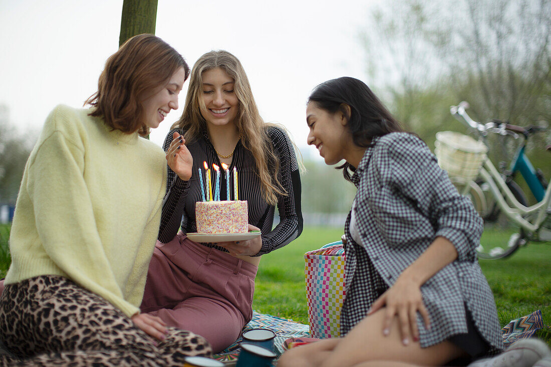 Happy young female friends celebrating birthday