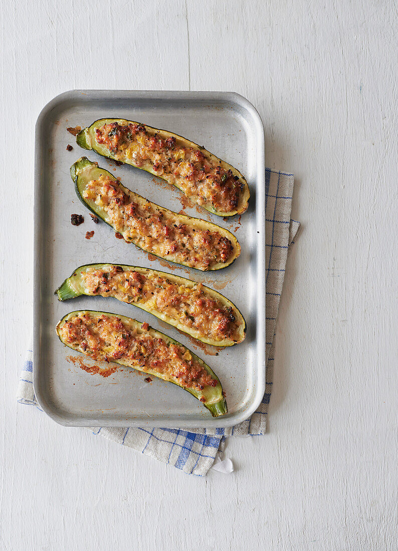 Sausage and herb stuffed courgettes