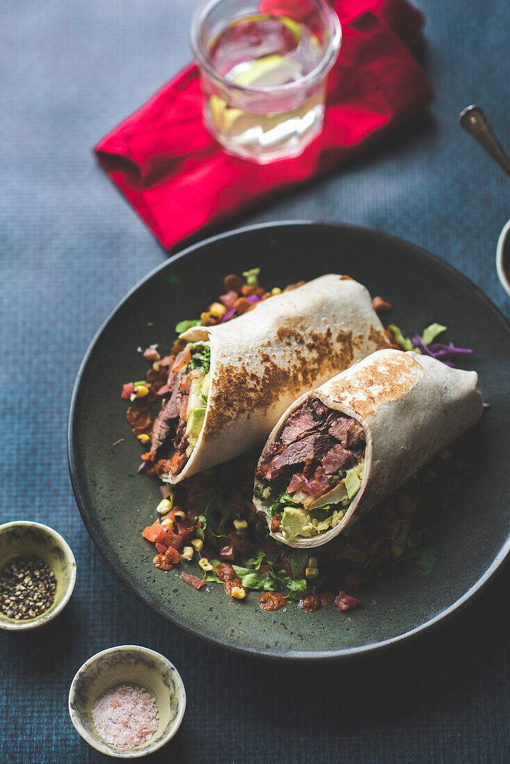 Beef burrito with avocado and tomatoes