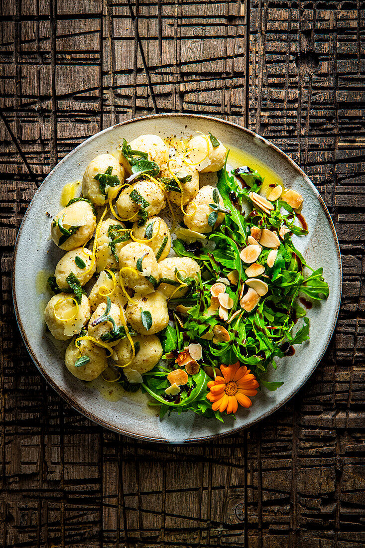 Ricotta gnocchi in sage butter with rocket and almond salad