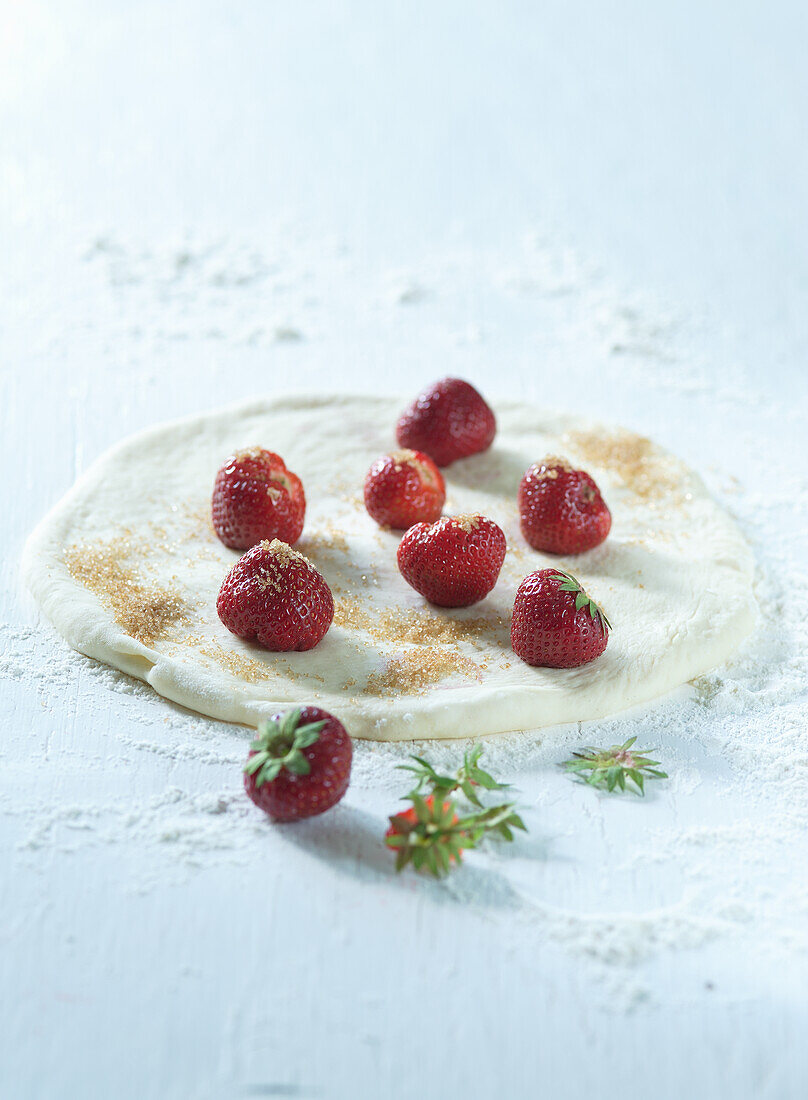 Sweet pizza dough with cinnamon sugar and strawberries