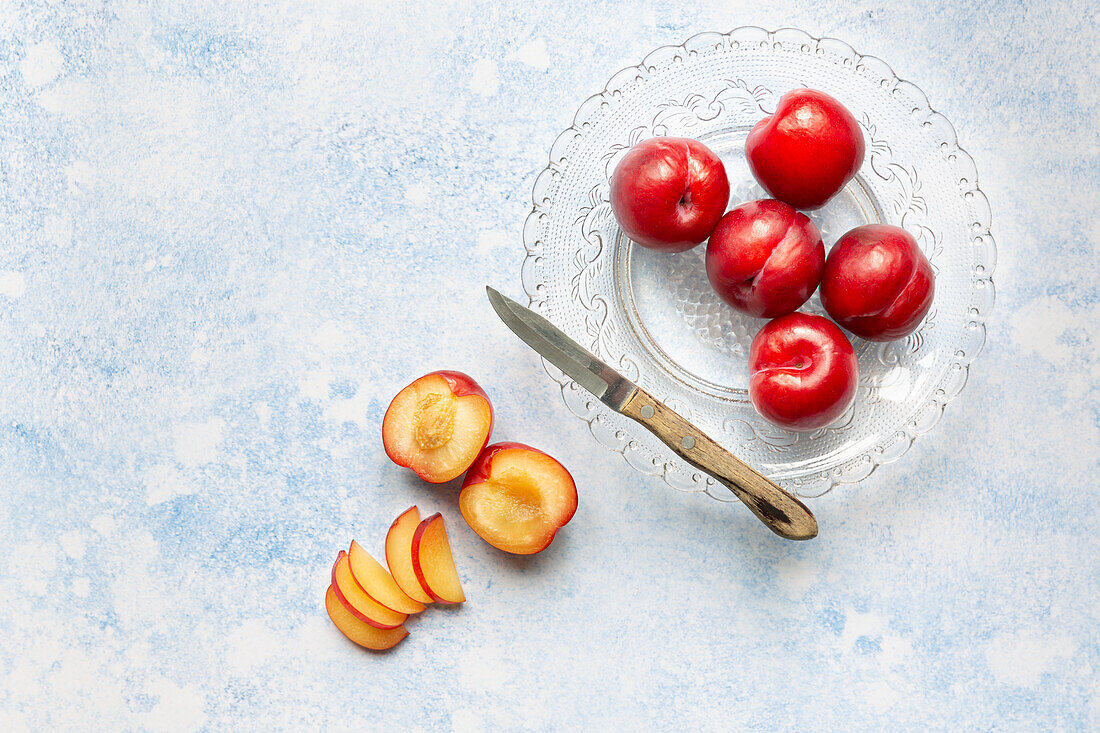 Red plums, partially sliced